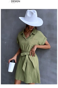 Detail of grass green cotton linen shirt dress with waist tie and button-up front