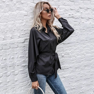 Women's black long sleeve lapel shirt with waist tie and large chest pockets
