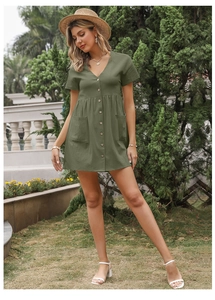 Close-up of olive green cotton linen mini dress with button front and large patch pockets