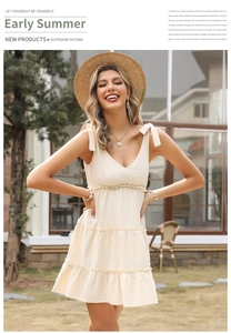 Detail of V-neck tiered cotton linen summer dress with adjustable shoulder bow ties