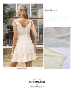 Detail of ruffled tiered skirt and tie shoulders on linen V-neck summer dress