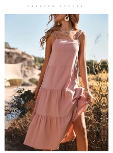 Detail of pink tiered midi dress with spaghetti straps and a flowing linen-blend fabric