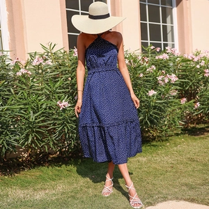 Navy blue polka dot halter maxi dress with waist belt and ruffled hem for summer vacations