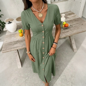 Close-up of V-neck cotton linen dress with button detail and sleeve tie in sage green
