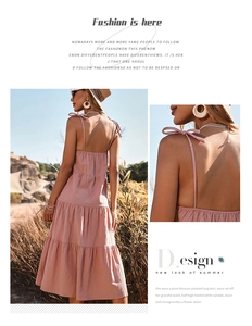 Detail of pink tiered midi dress featuring dainty shoulder bows and breathable fabric