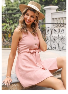 Detail of pink V-neck dress featuring wooden buttons and an adjustable waist tie