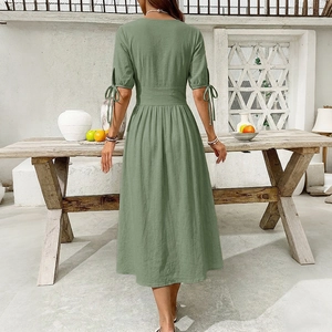 Detail view of sage green midi dress featuring drawstring short sleeves and waist pleats