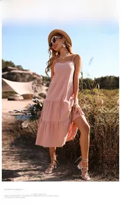 Detailed low angle view of a tiered pink cotton linen backless maxi dress in nature