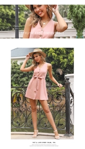Detail view of pink V-neck sleeveless button-down dress with waist tie and cotton texture