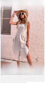 Detail of beige cotton linen dress showing button-down front and split hem design