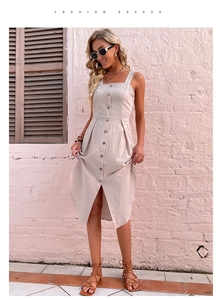 Detailed view of beige cotton linen dress with buttons and chic waist tailoring