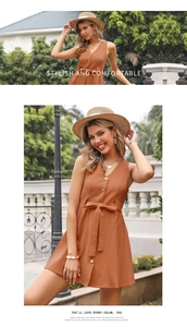Detail of orange V-neck dress with buttons and bow tie waist in a summer outdoor setting