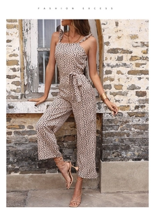 Detail view of leopard print jumpsuit with ruffled straps and waist tie in outdoor setting
