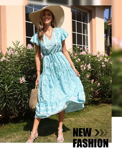 Detail of light blue floral summer dress with V-neckline and ruffled short sleeves