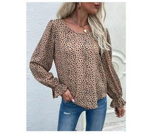 Detail showing ruffled cuffs and leopard print fabric on women's long sleeve shirt