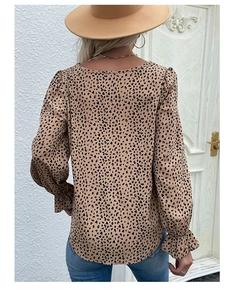 Detail showing back view of leopard print top with ruffled cuffs and crew neckline