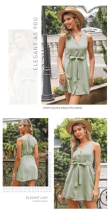 Detail view of light green V-neck dress with wooden buttons and waist tie design