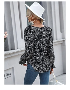 Detail of floral printed blouse featuring ruffled elastic cuffs and elegant chiffon fabric