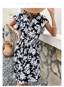Detail of floral summer dress featuring ruffle sleeves and adjustable waist tie belt