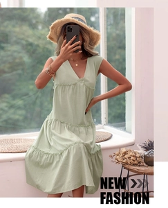 Detail view of a light green V-neck sleeveless tiered cotton linen summer midi dress