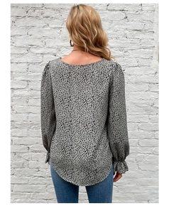 Detail view of women's leopard print blouse showing back silhouette and lantern sleeves