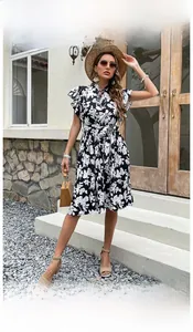 Detail of floral printed summer dress with ruffled sleeves and matching waist belt tie