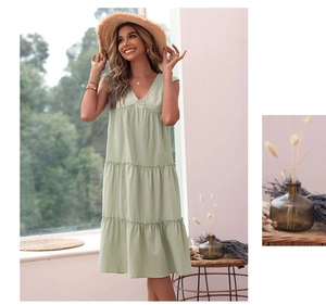 Detail of light green V-neck sleeveless cotton linen tiered summer midi dress with pleats