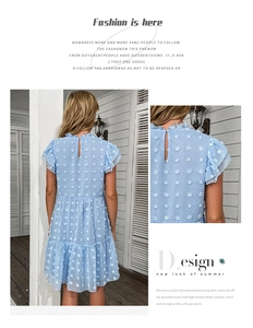 Close-up detail of light blue Swiss dot chiffon dress with ruffled collar and tiered hem