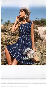 Detail of navy blue polka dot dress with pleated hem and stylish waist tie belt