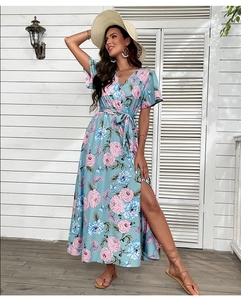 Detail of light blue floral maxi dress with waist tie and elegant side slit design