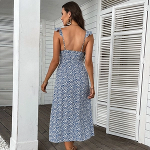 Blue and white floral sundress featuring an open back and ruffled straps for summer