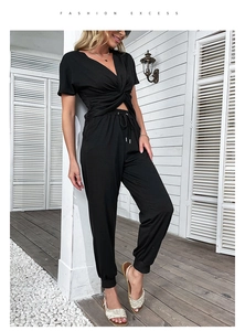Detail view of women's black two-piece set featuring twist-knot V-neck top and drawstring pants