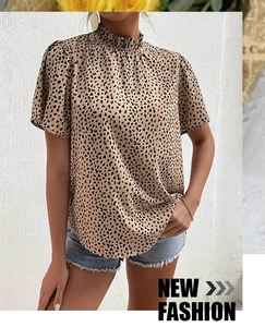 Close-up of leopard print short sleeve blouse with elegant ruffled high neck collar