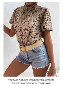 Detail of leopard print short sleeve blouse with ruffle stand collar and summer style