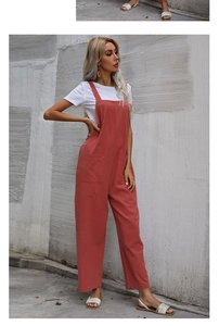 Detail of loose fit vintage rust red overalls with large pockets and wide leg cut