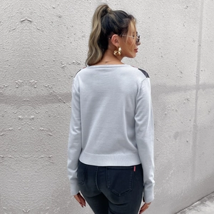 Women's light grey crew neck knit sweater with red and black plaid shoulder patterns