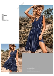 Detailed shot of blue polka dot summer dress with pleated hem and waist tie design