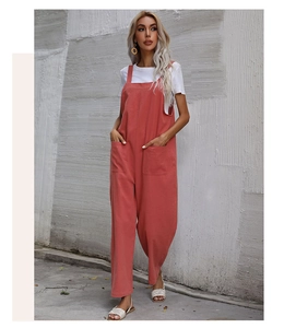 Macro detail of the vintage coral pink overalls with large side pockets and soft cotton texture