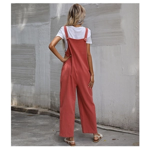 Back view of brick red wide leg overalls with adjustable straps and button details