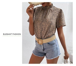 Detail of leopard print blouse with ruffle neck collar and casual denim shorts