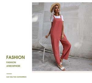 Detail view of pink sleeveless overalls with two front pockets and natural cotton linen texture
