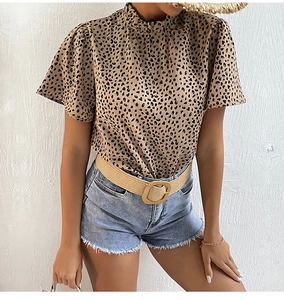 Detail shot of leopard print chiffon top with ruffle neckline and denim shorts