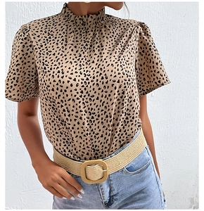 Detail of leopard print short sleeve blouse featuring a ruffled high collar and soft fabric