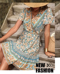 Detail of bohemian V-neck wrap dress with floral print and adjustable waist tie