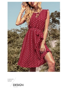 Red polka dot summer dress featuring ruffled sleeves and a pleated skirt with waist tie