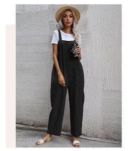 Detail of black loose-fit jumpsuit with pockets and breathable fabric for women
