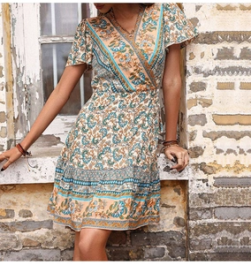 Detail of bohemian floral wrap dress with V-neckline and intricate paisley pattern