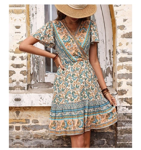 Detail of bohemian floral print wrap dress with V-neckline and ruffled short sleeves