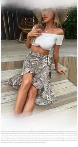 Detail of white off-shoulder ruffled top and paisley print wrap skirt fabric texture