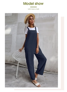 Detail of loose fit navy blue cotton linen jumpsuit with square neck and large side pockets